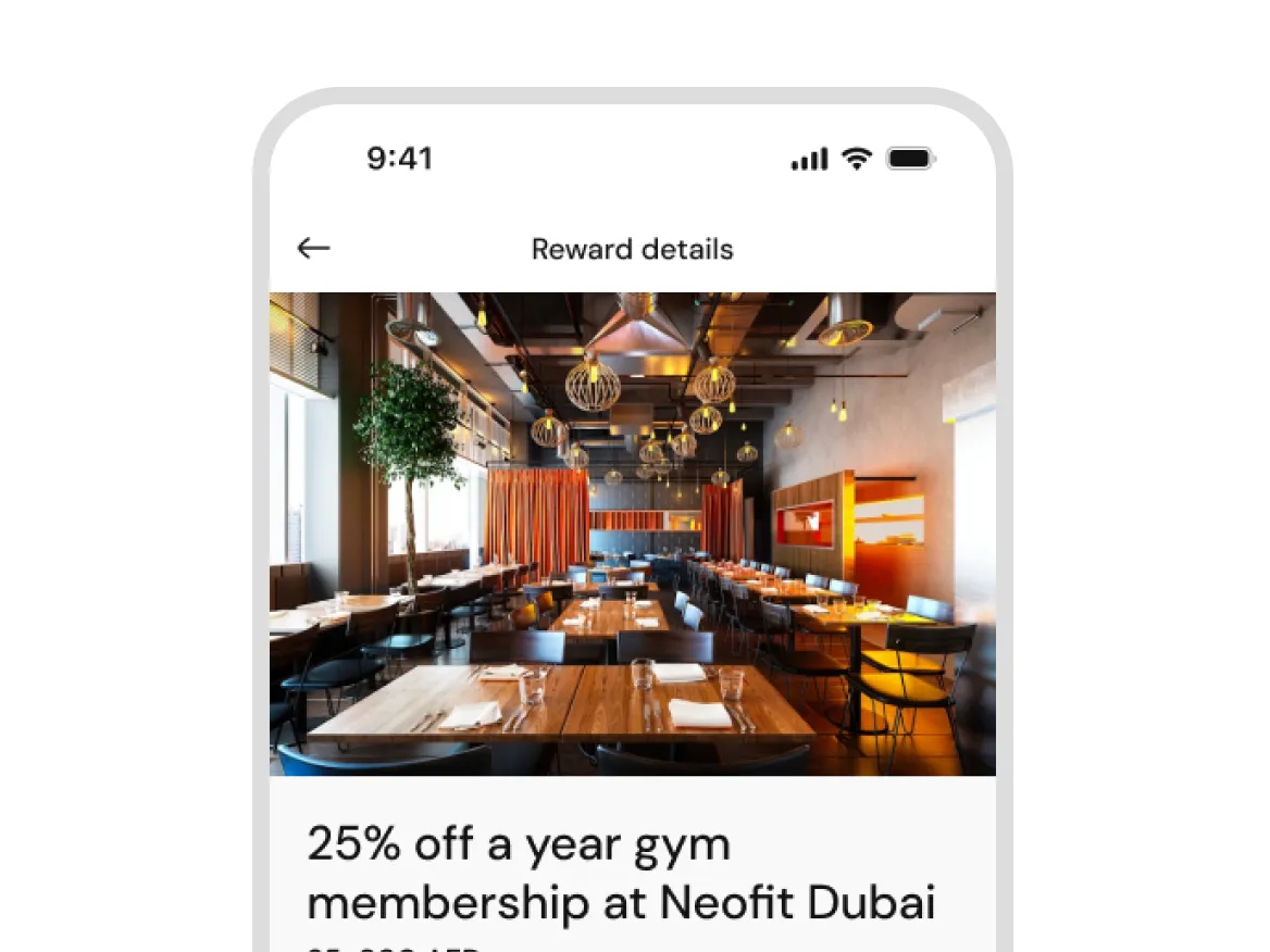 Mobile screen showing reward details with a modern restaurant interior photo above the text.