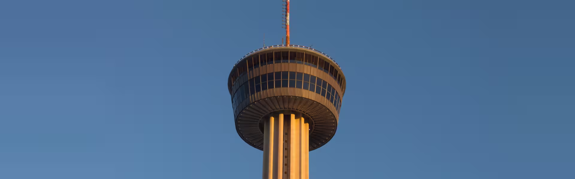 Tower of the Americas in San Antonio against a clear blue evening sky