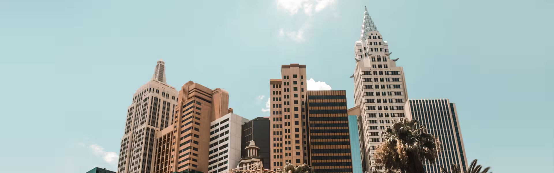 Modern city skyline with tall skyscrapers under clear sky, featuring diverse architectural styles