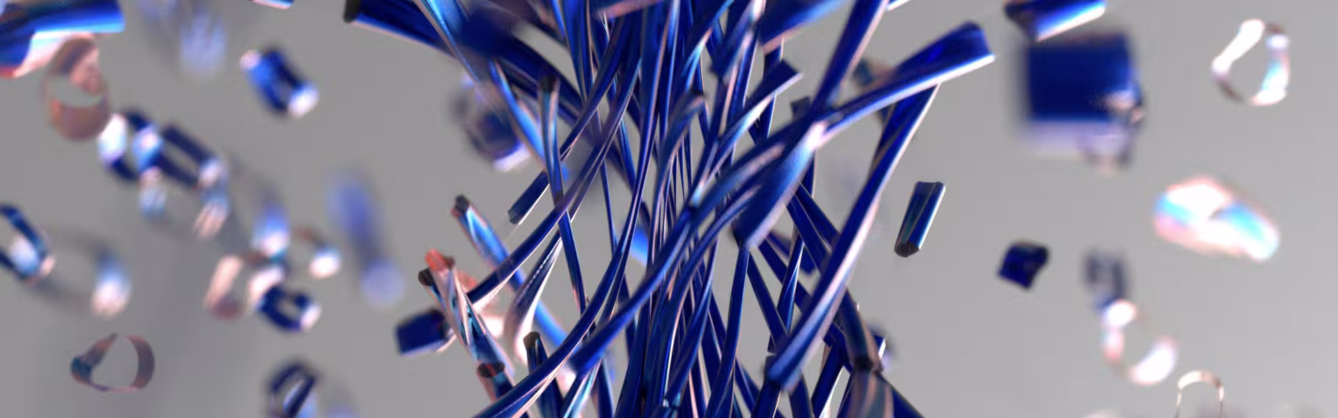 Abstract 3D render of metallic blue ribbons twisting and scattering in motion, representing digital innovation and creative design concepts