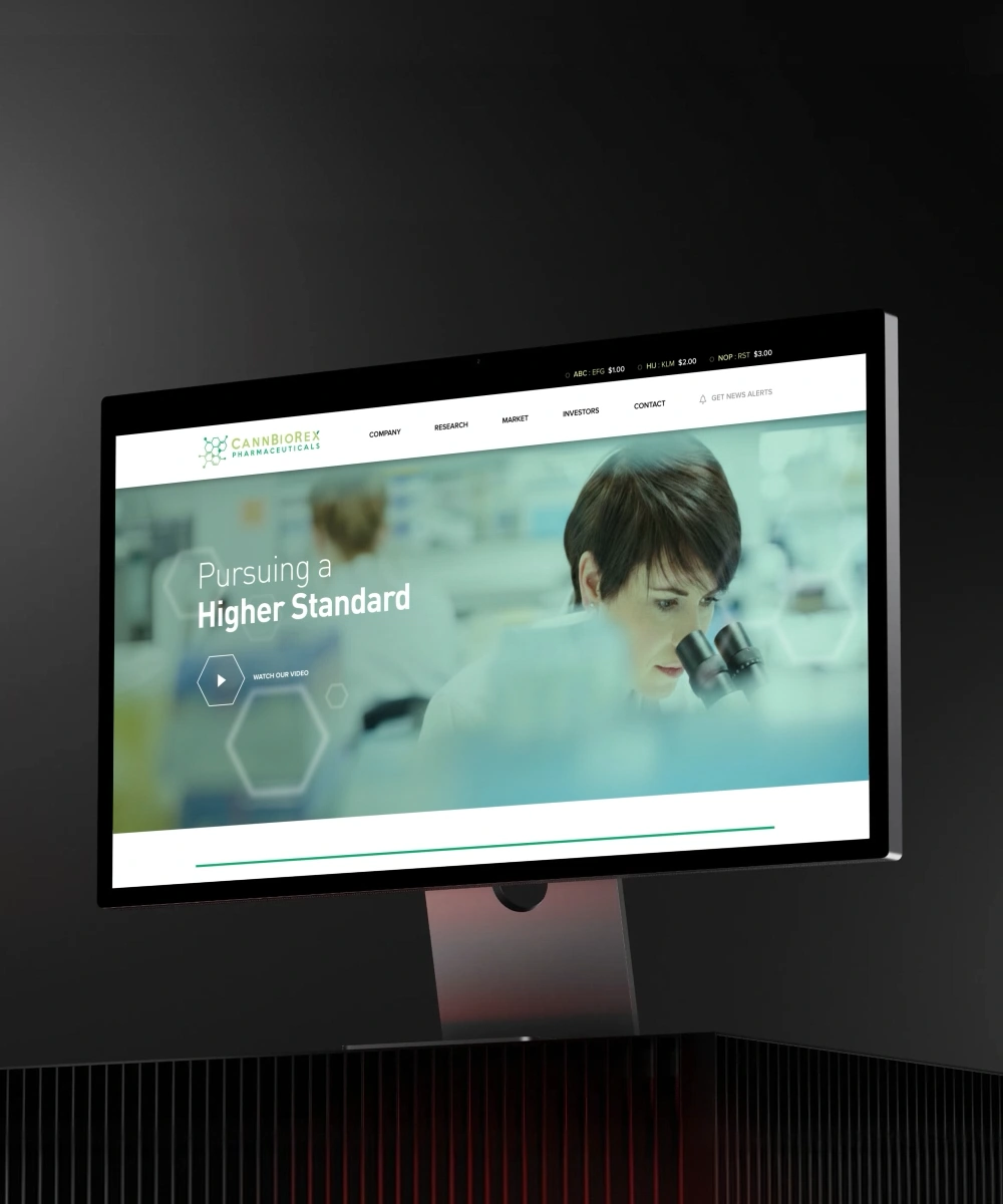 CannBioRex Pharmaceuticals website displayed on a desktop monitor, featuring a laboratory researcher using a microscope and the headline “Pursuing a Higher Standard.”
