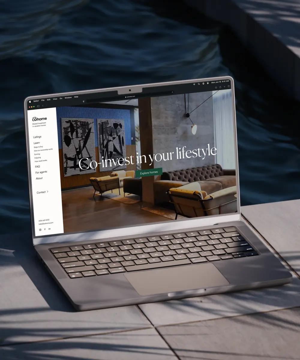 A laptop displays a real estate website featuring modern interior design, with the tagline "Go invest in your lifestyle."