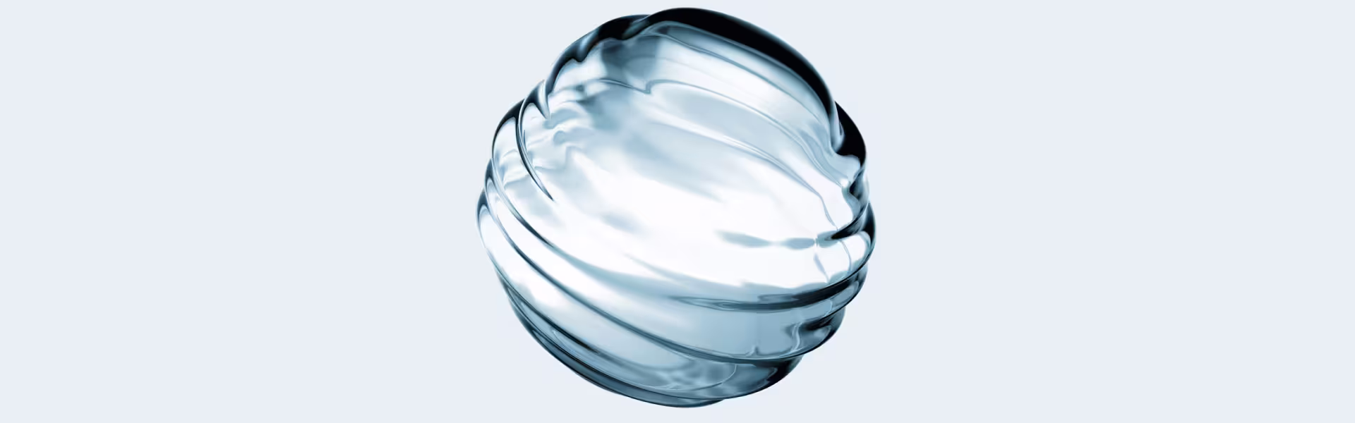 A translucent, ribbed glass sphere refracting light against a pale blue-gray background — an abstract visual representing transparency.