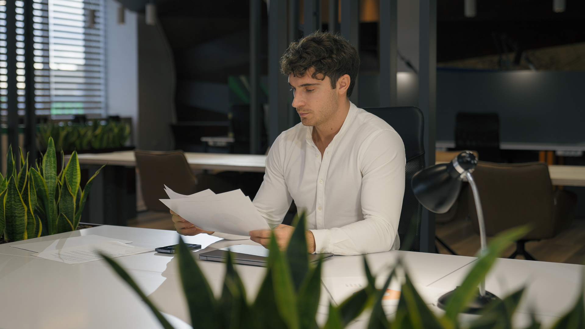 Professional reviewing paperwork at a desk for trade promotion optimization