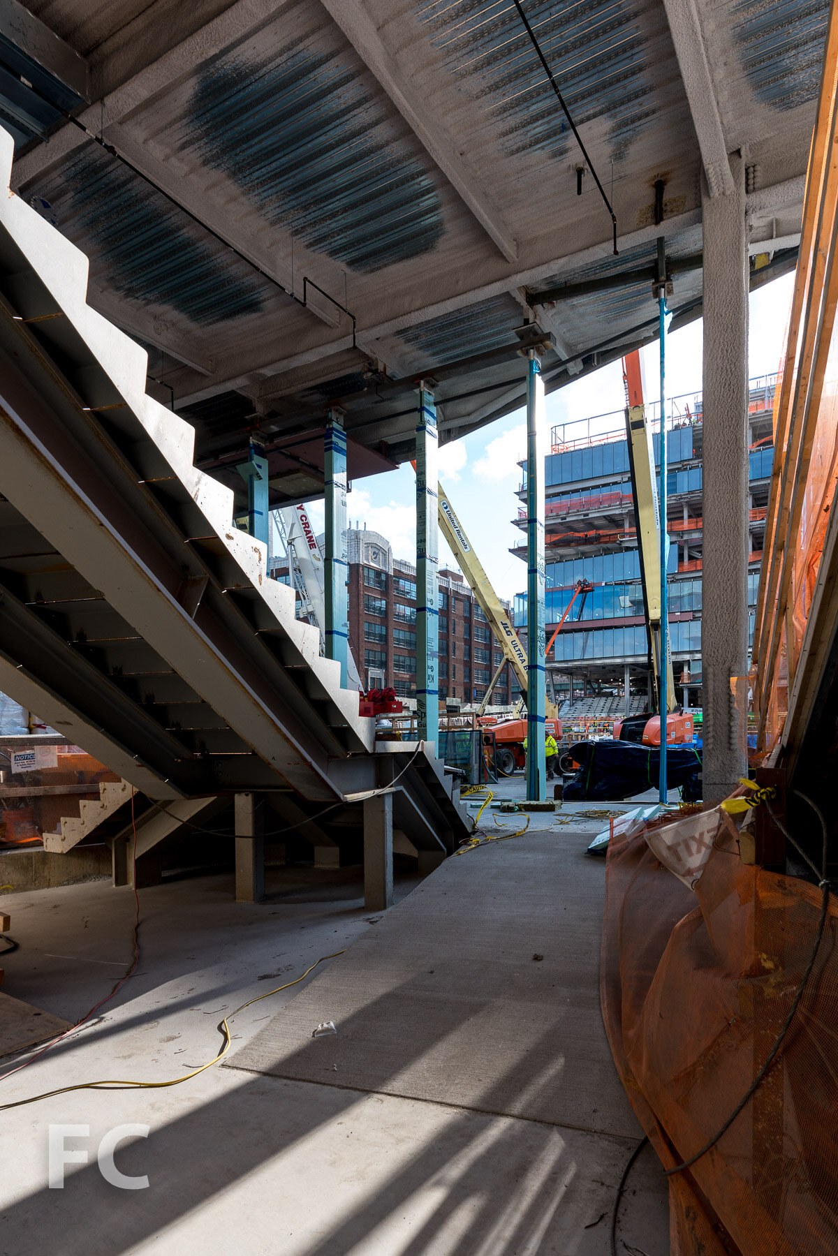 Kravis Hall under construction, with the ground-floor storefront and tall glass fins