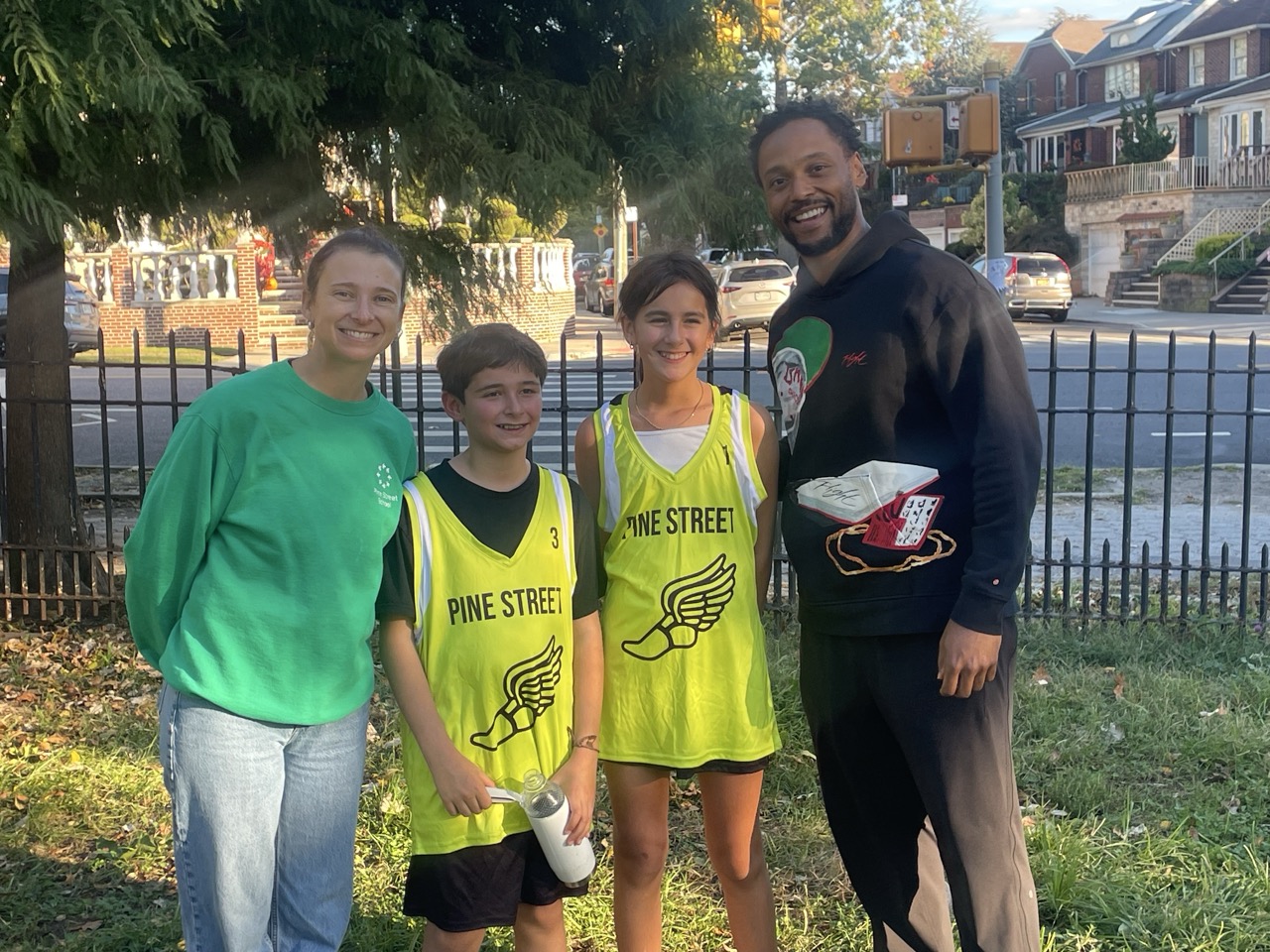 Cross country teammates with their coaches at a meet