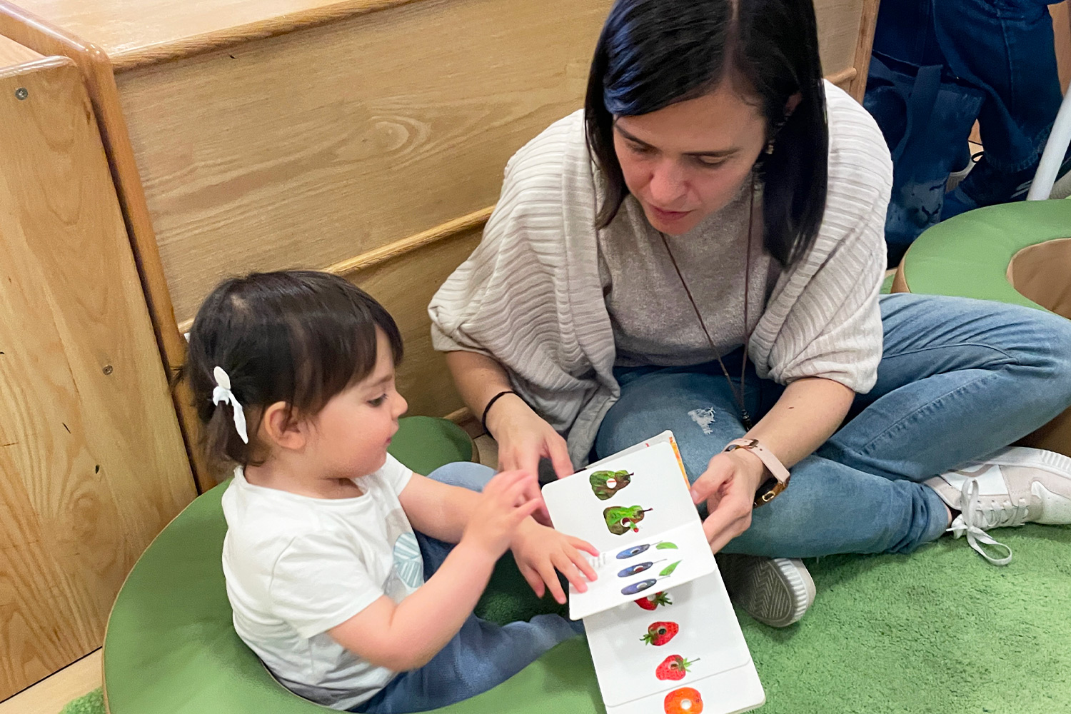 Pine Street School parent with her child during a classroom visit.