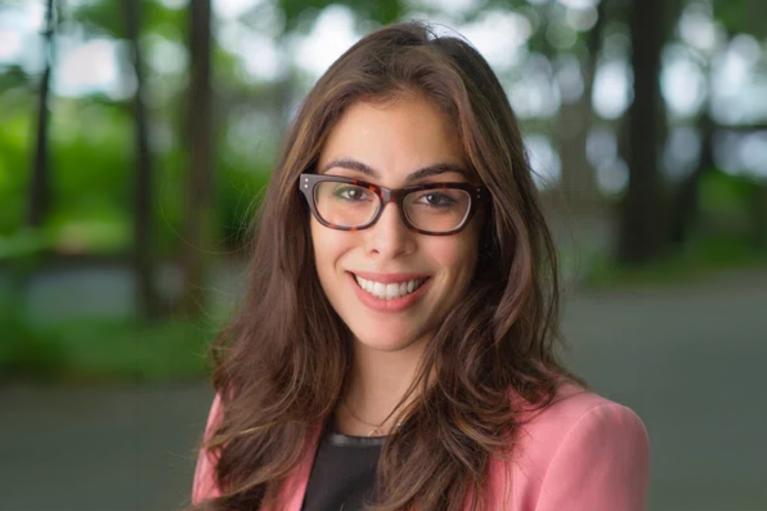 Pine Street School's Head of School, Anna Rita Pergolizzi-Wentworth, pictured against a forest background in a professional portrait.