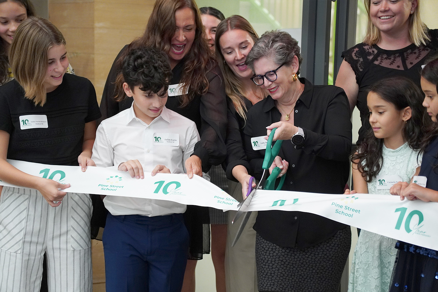 Students and staff cut the ribbon at Pine Street School's 10 Year Anniversary.
