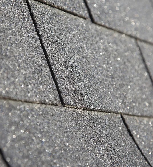 Close-up view of gray asphalt roof shingles arranged in an overlapping pattern.