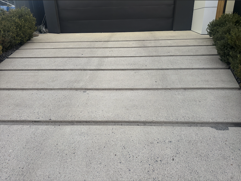 Mega Clean technician pressure cleaning an outdoor surface