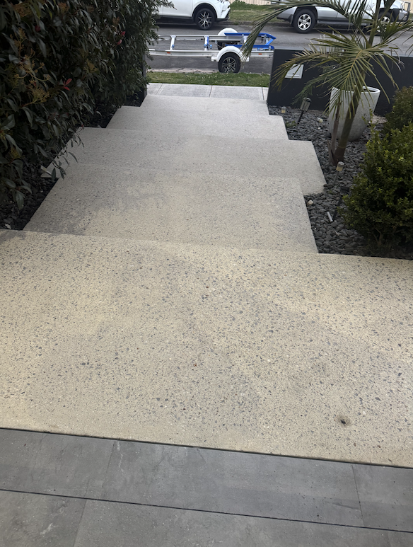 Mega Clean technician pressure cleaning an outdoor surface