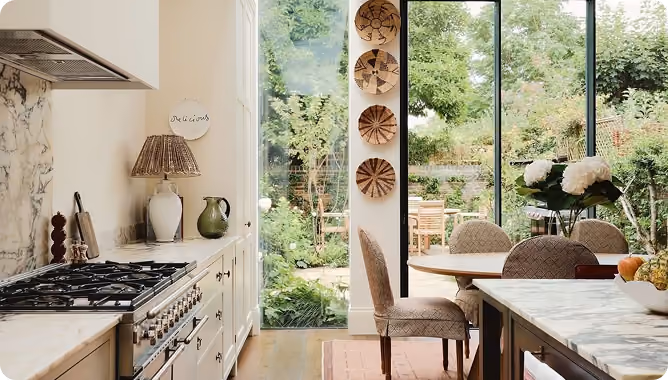 a kitchen with large glass windows letting in natural light