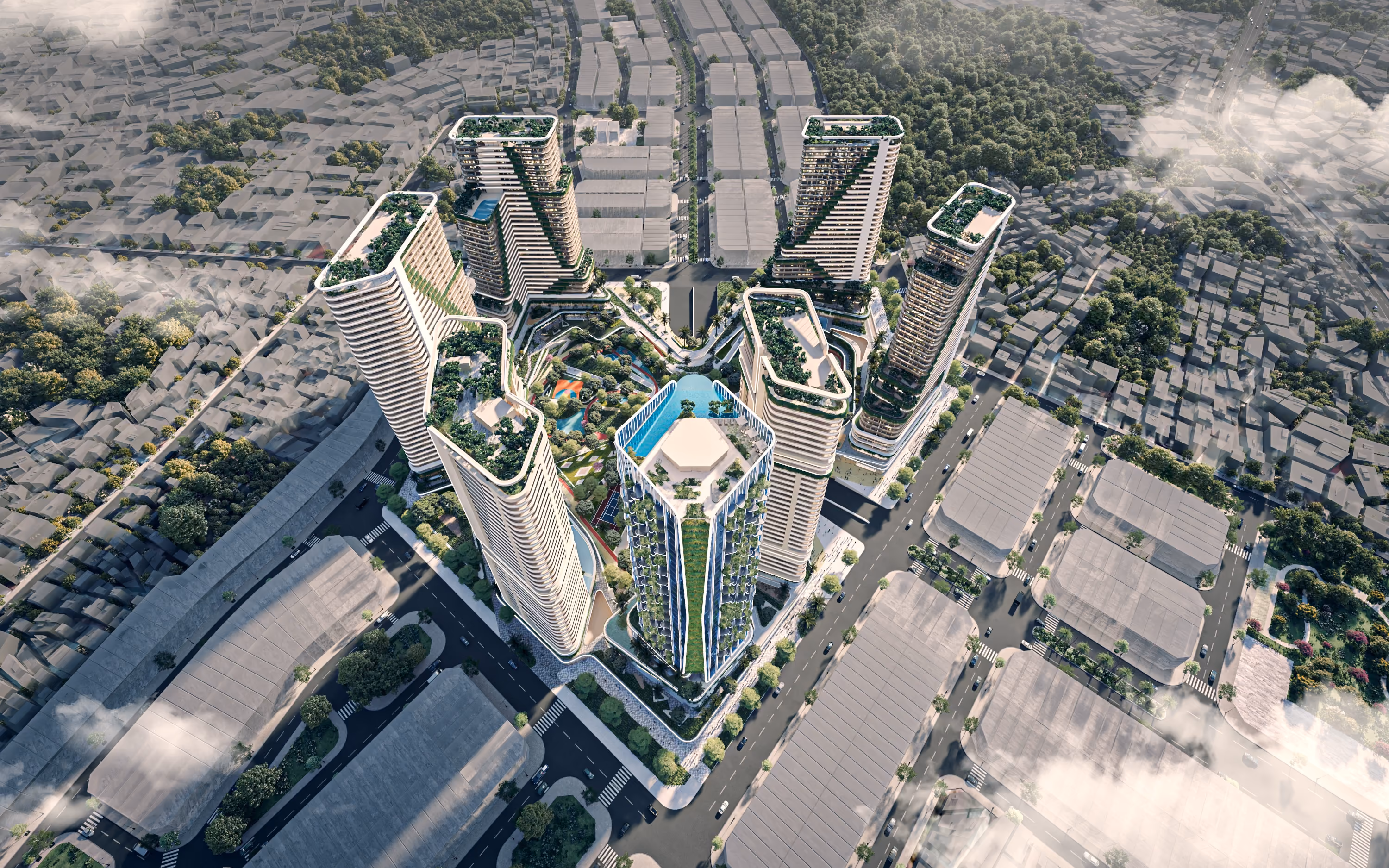 Aerial view of a modern urban complex with tall buildings and rooftop greenery.