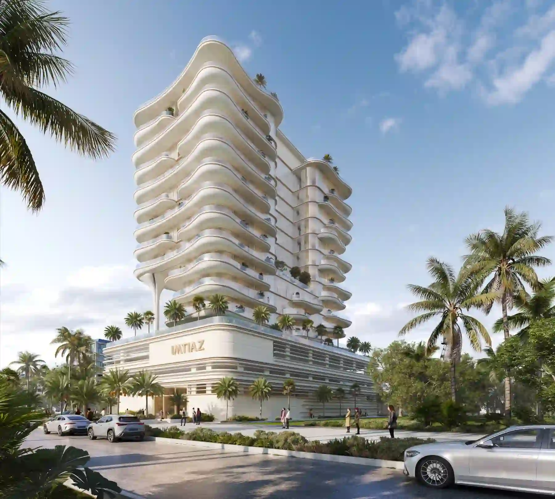 Modern white building with curving balconies, surrounded by palm trees and parked cars under blue sky.