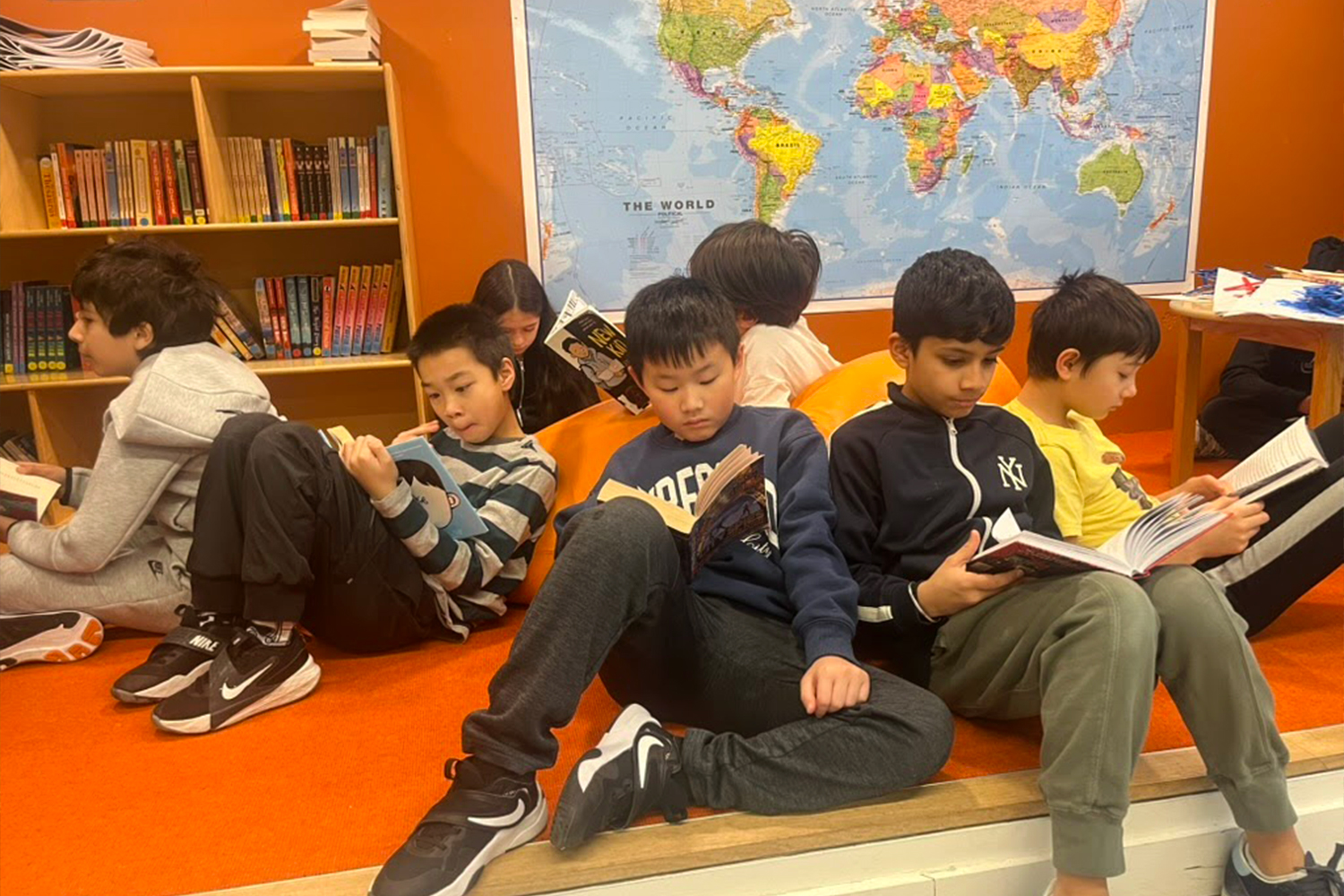 A group of students gathered together and focused on reading