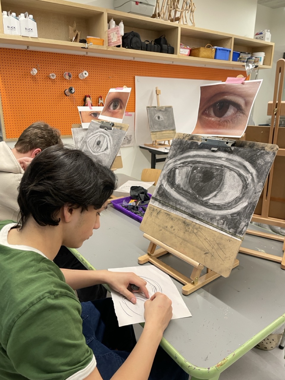 Middle school students draw images of eyes during art class