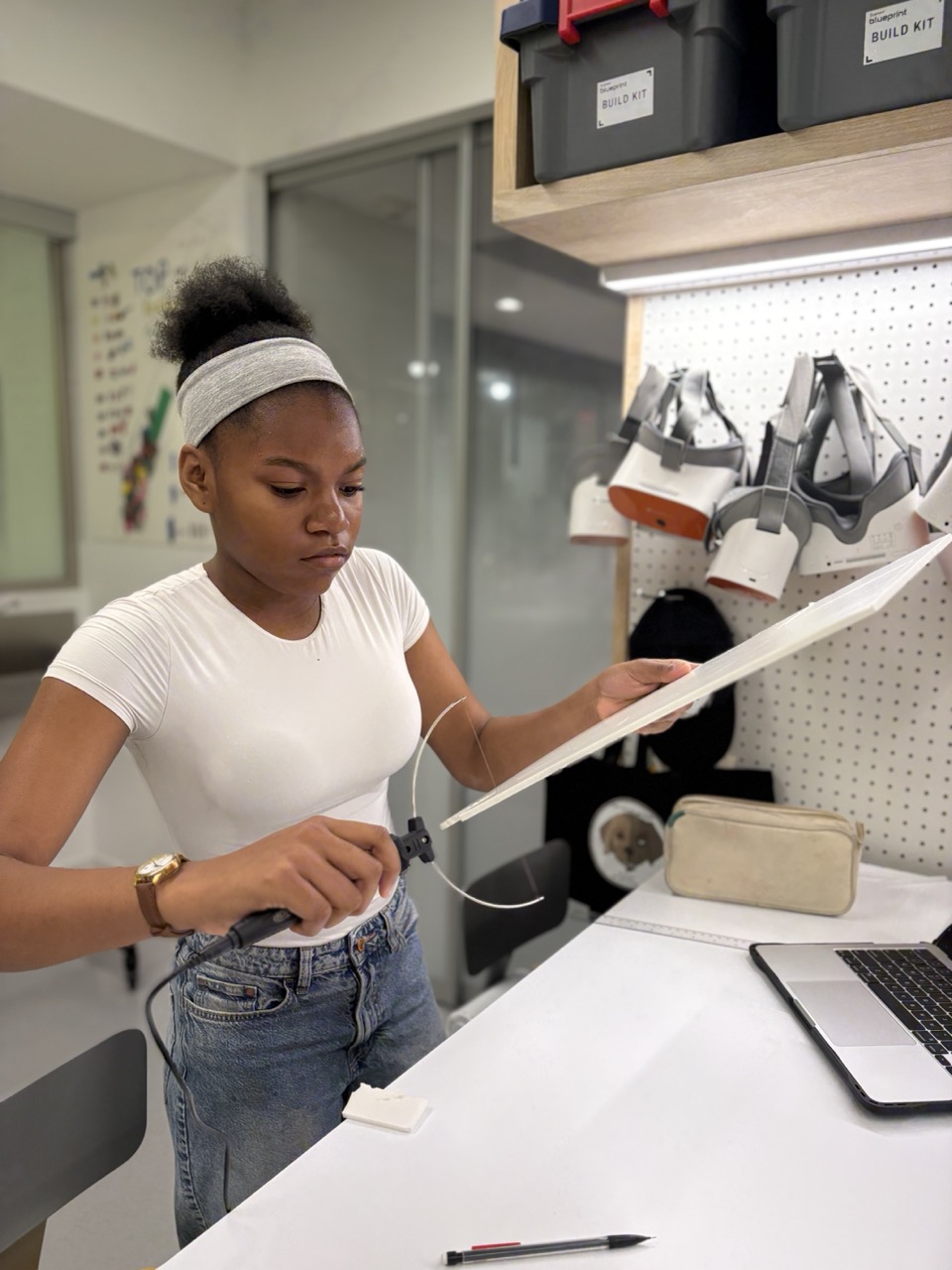 middle school student using a foam board cutter in the Design Lab