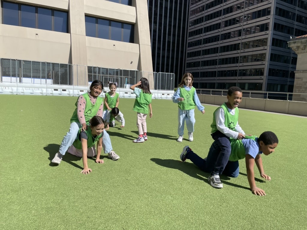 Students having fun and playing games on the turf during recess