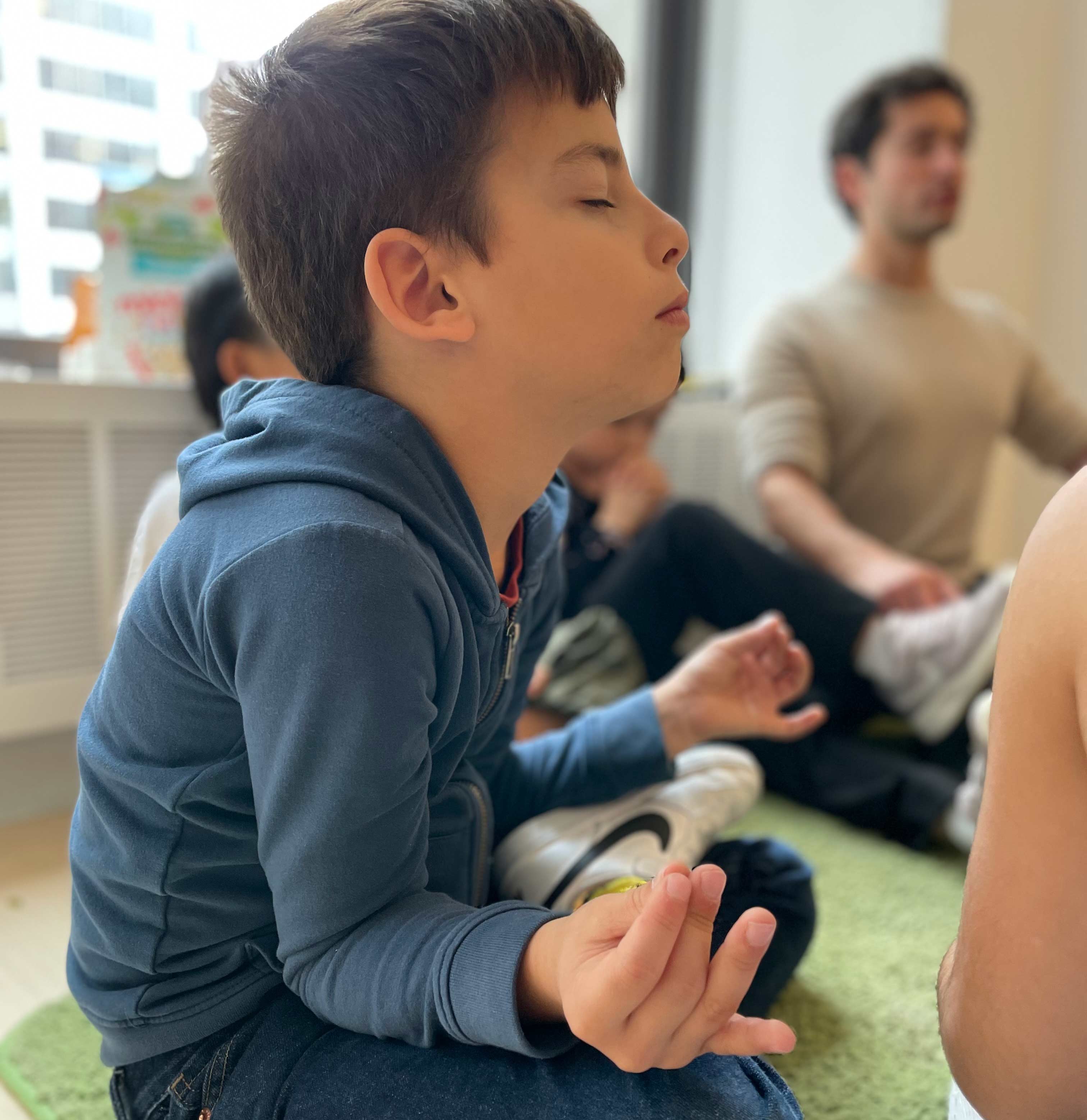 A student having a moment of meditative calm in the classroom guided by a teacher