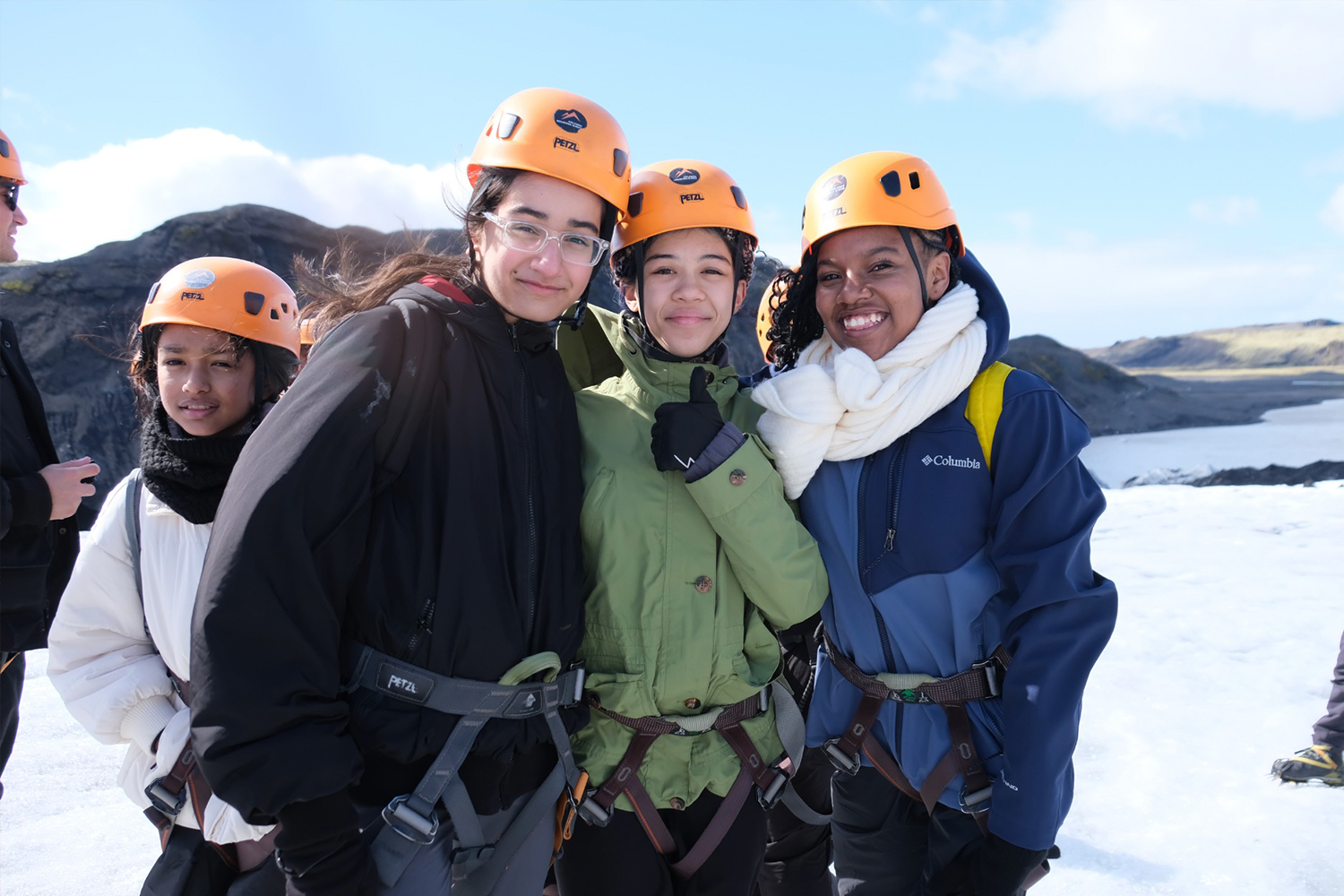 Students smiling in a group photo in Iceland while visiting glacier