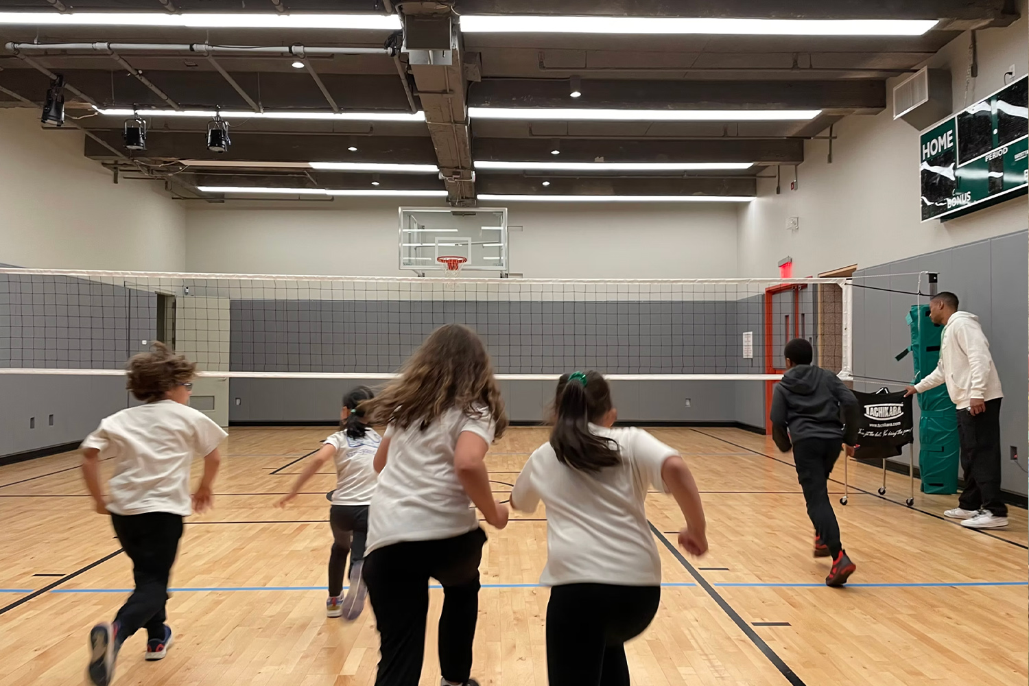 Students running during P.E. class in the middle school gym