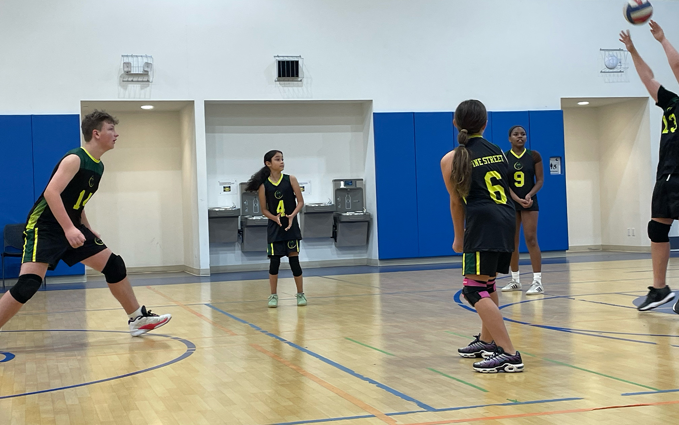 Volleyball team in action in a school gymnasium