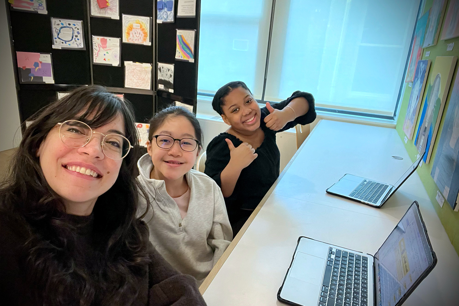 Teacher working with students on a project