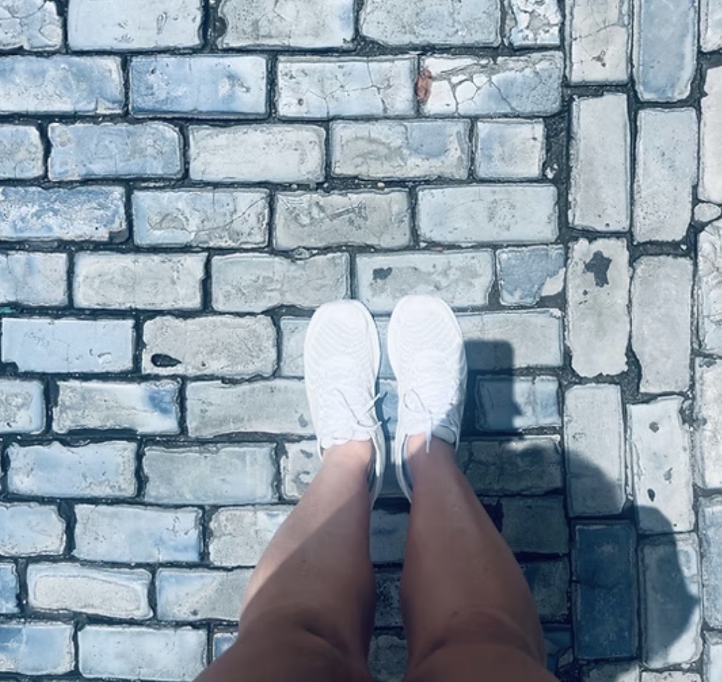 Image of feet walking on cobblestone street