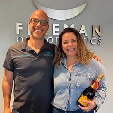 Smiling adult patient with Dr. Freeman at Freeman Orthodontics.