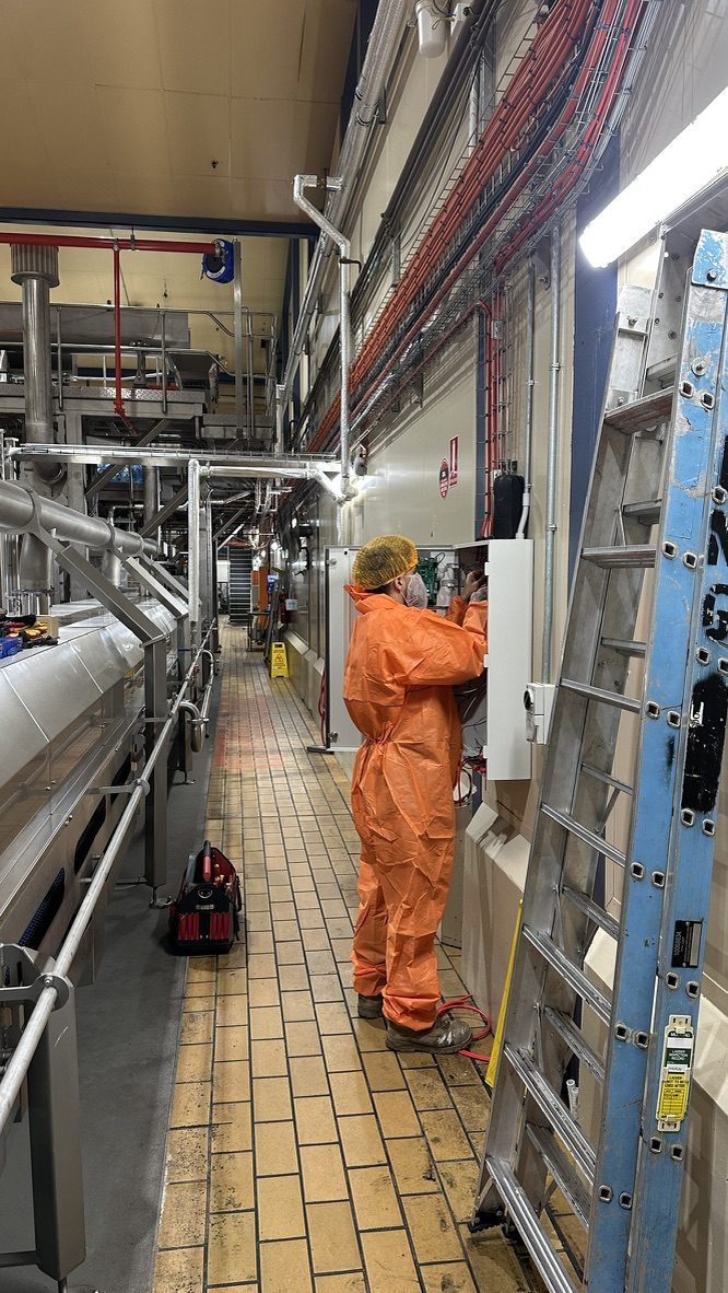 BBH electrician working in a commercial food production facility.