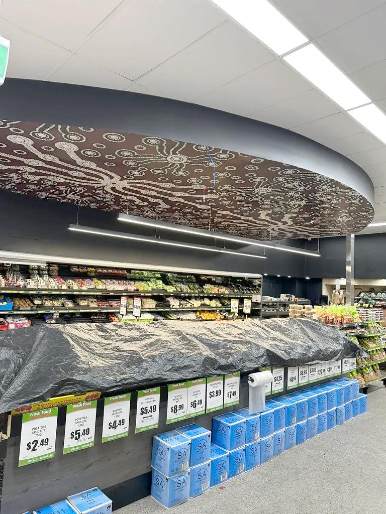 Custom ceiling lighting installation in a supermarket.