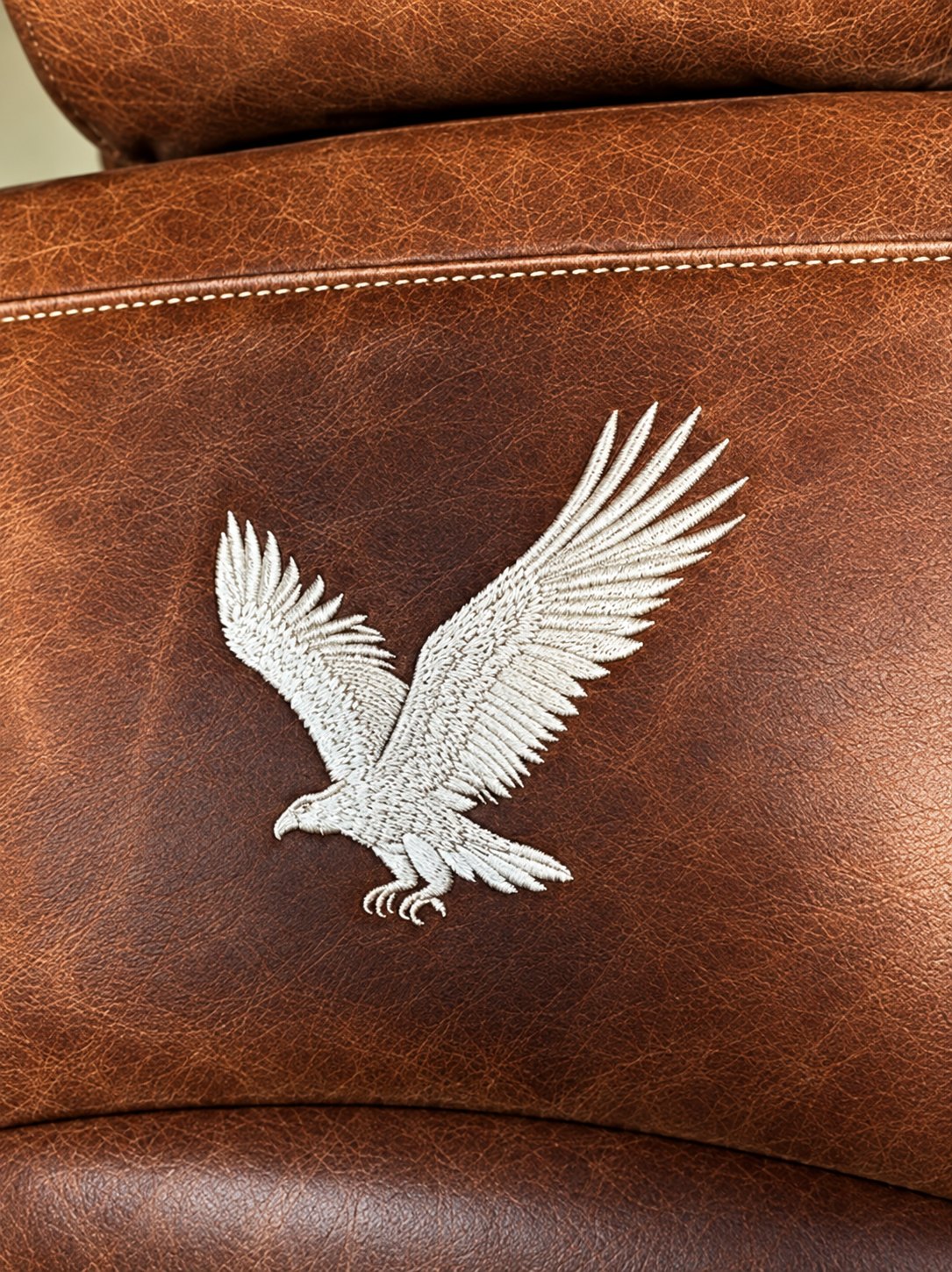 Eagle embroidery on distressed brown leather
