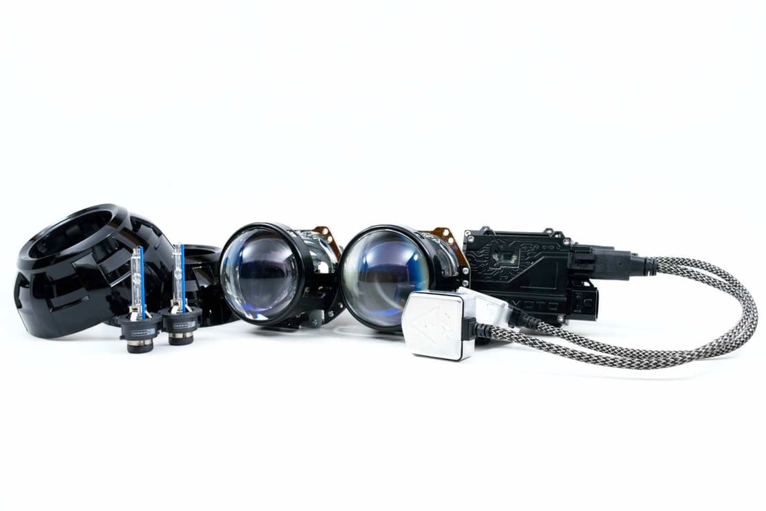 Aftermarket projector retrofit inside a headlight housing