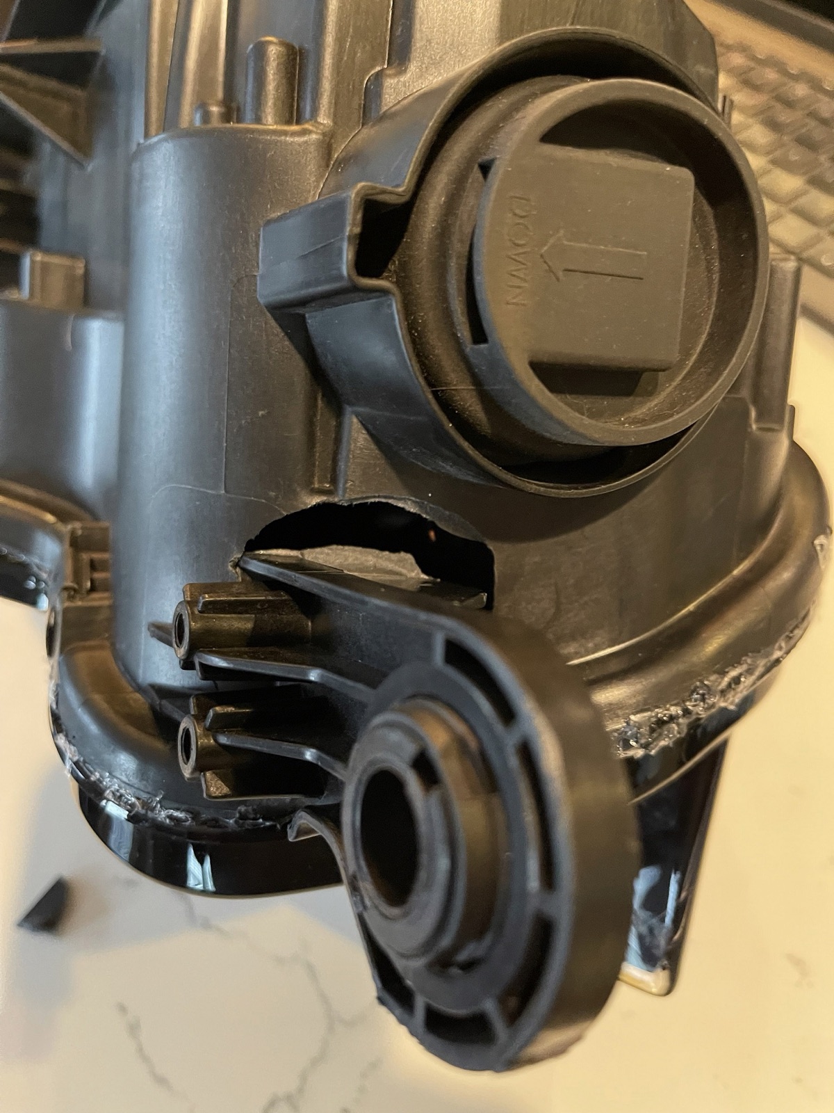Cracked headlight housing and mounting tab repaired by plastic welding