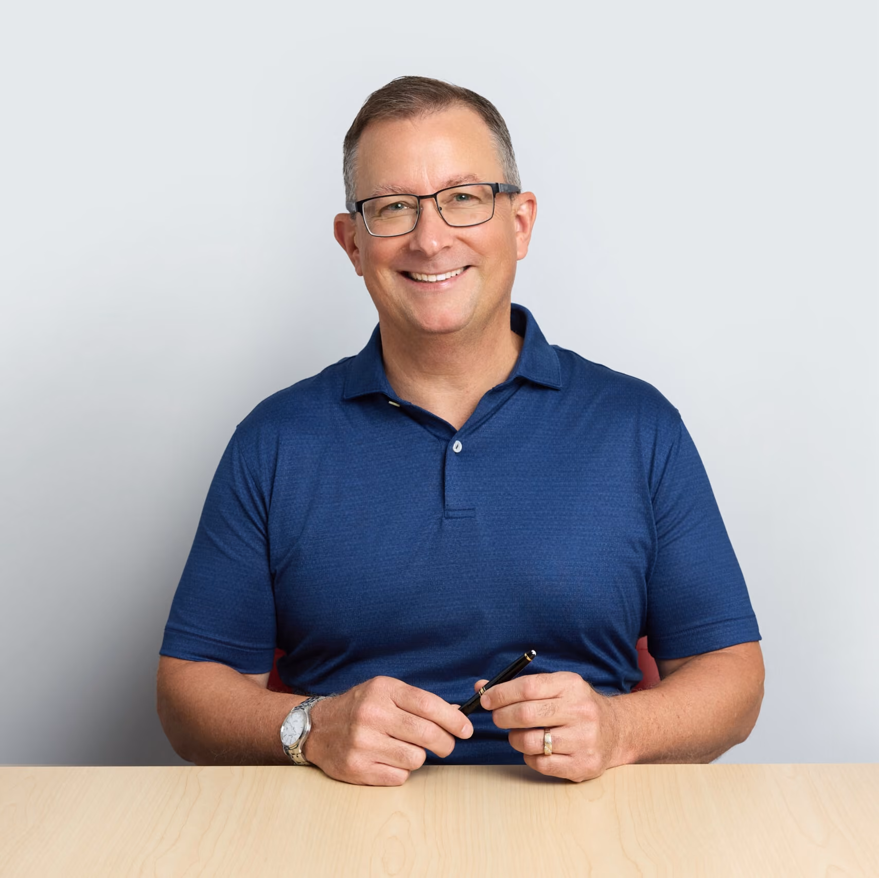 Headshot of Joe Zarzycki holding a pen