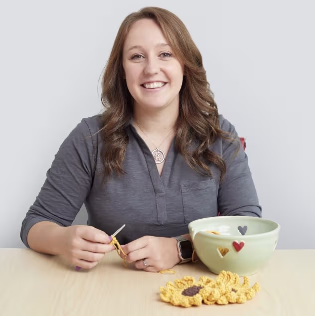 Headshot of Meagan DenOuden crocheting