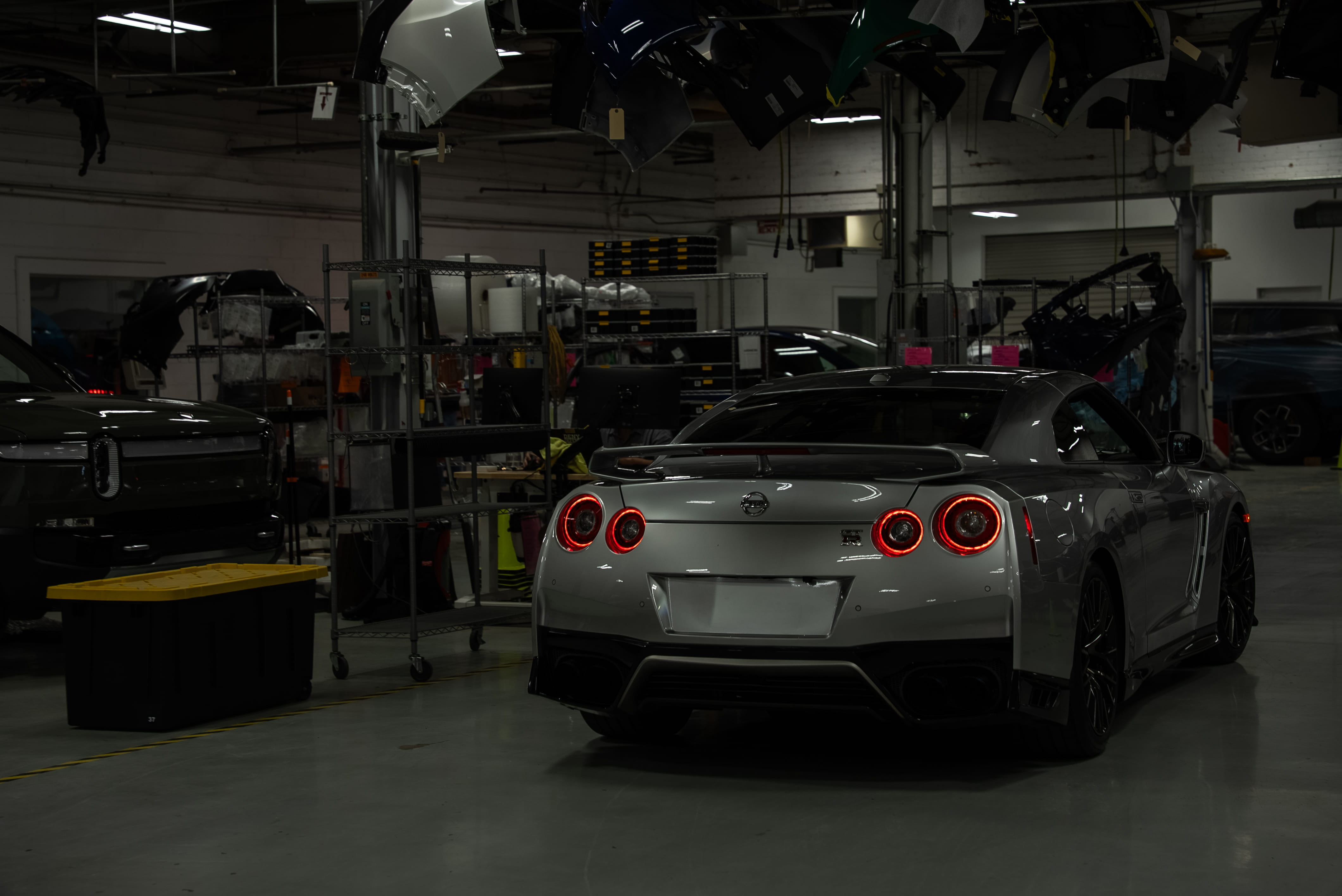 shot of a shining silver corvette being after being worked on at Body Builders Auto