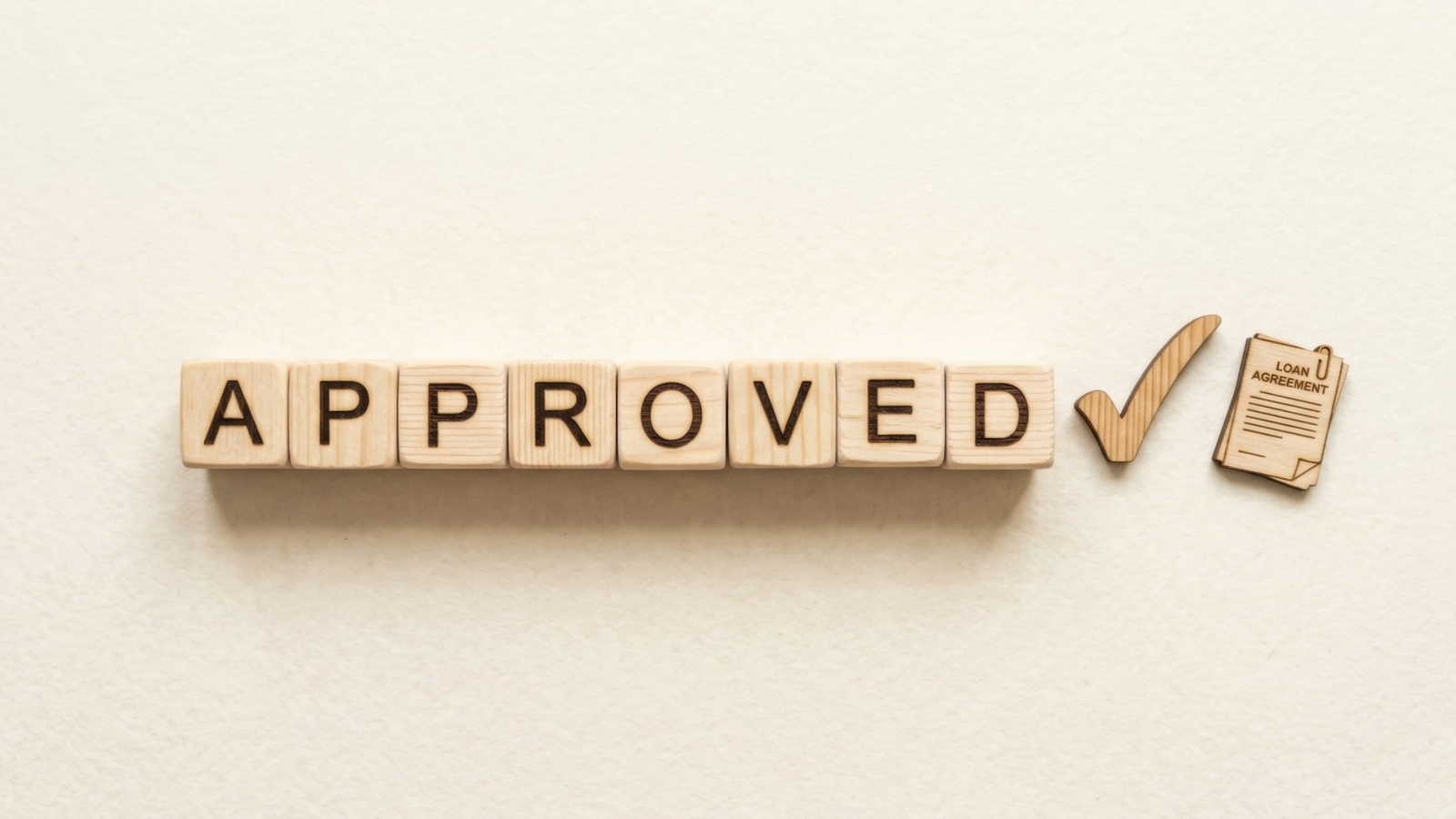 Letter blocks reading approved with a check mark alongside