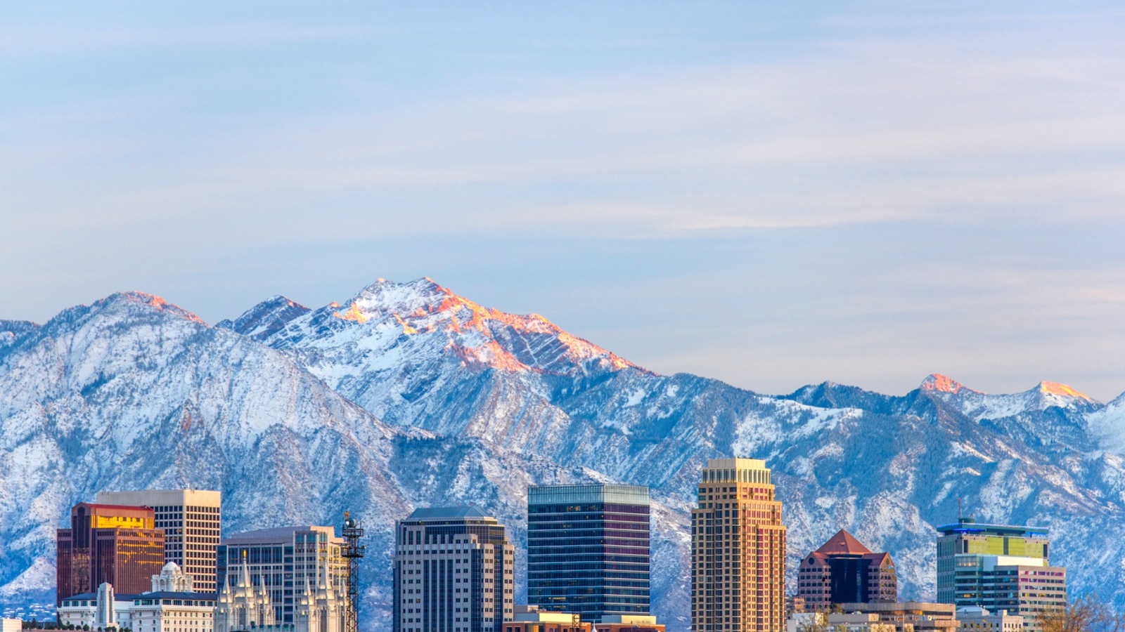 A winter skyline with fresh snow on the mountains behind it