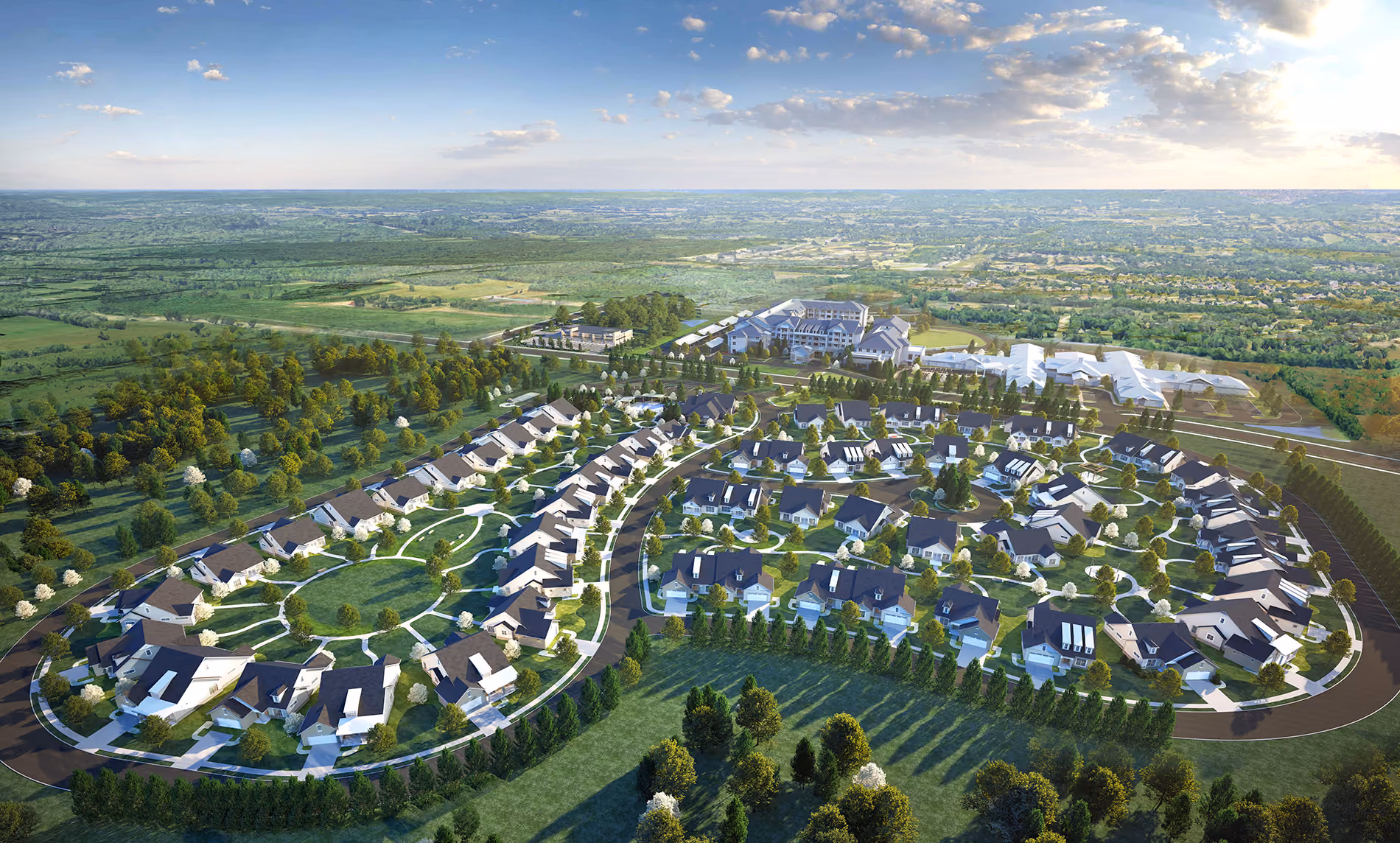 Aerial view of a suburban residential neighborhood with houses, trees, roads, and green open spaces.