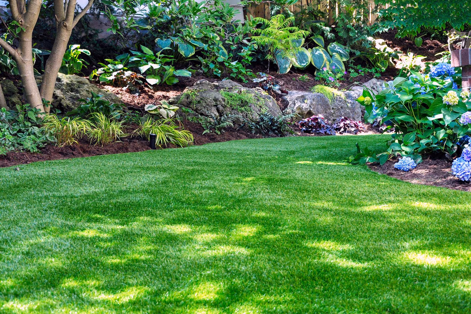 Professional residential landscaping by First Responders Land Care featuring clean landscape beds and well-maintained plants in Orlando, Florida