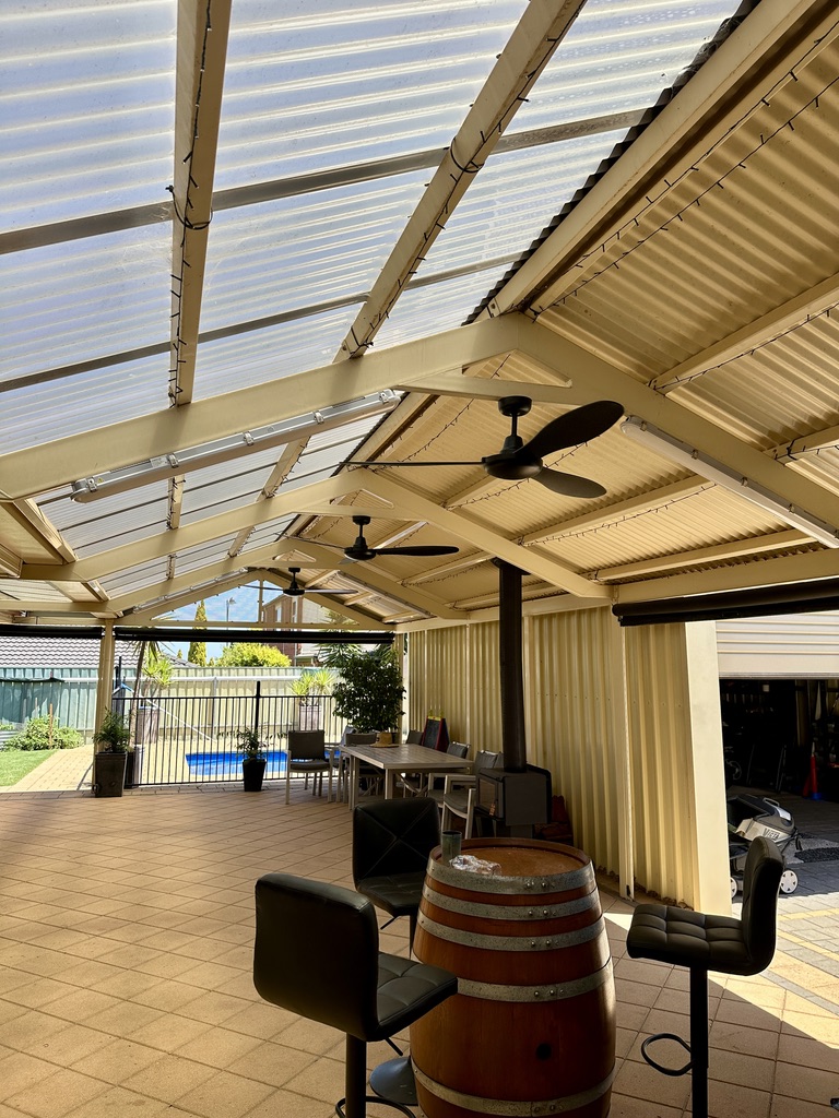 Ceiling fans and lighting installed in a covered outdoor entertaining area.