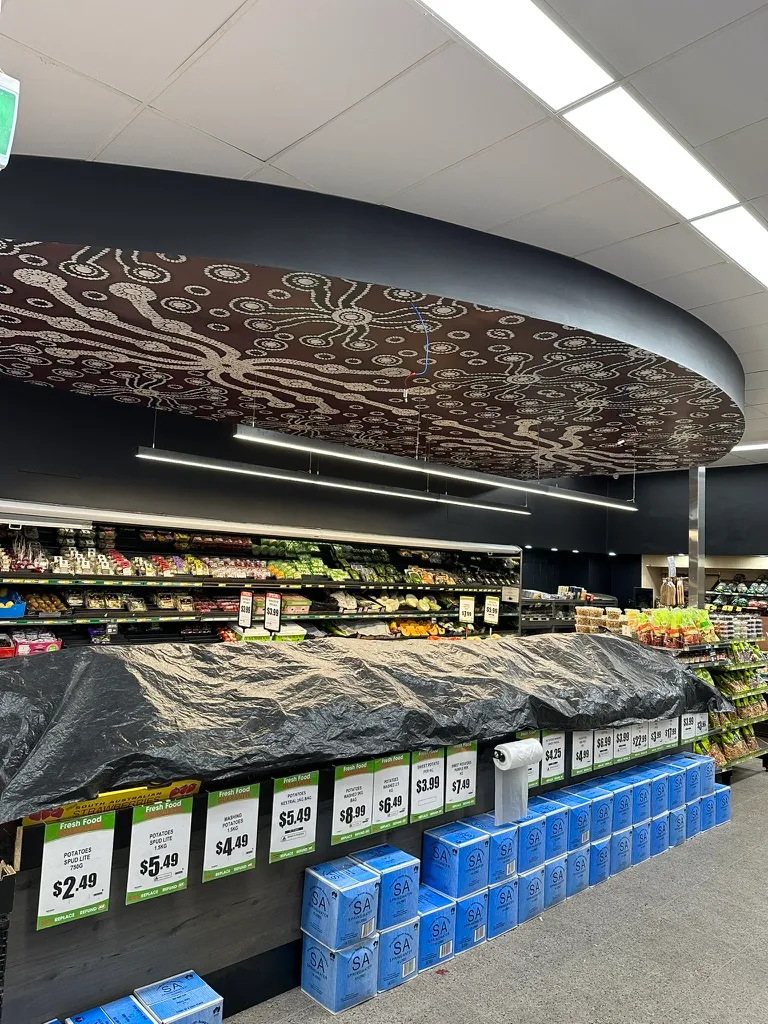 Custom ceiling lighting installation in a supermarket.
