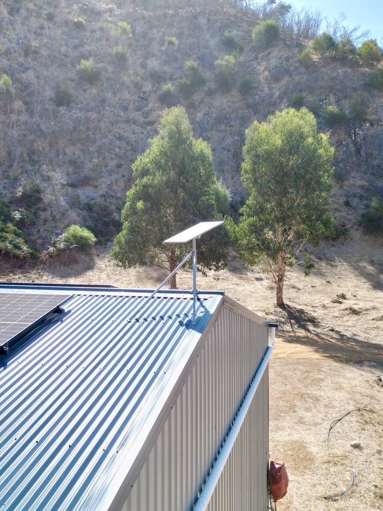 Starlink dish installed on a rural shed roof.
