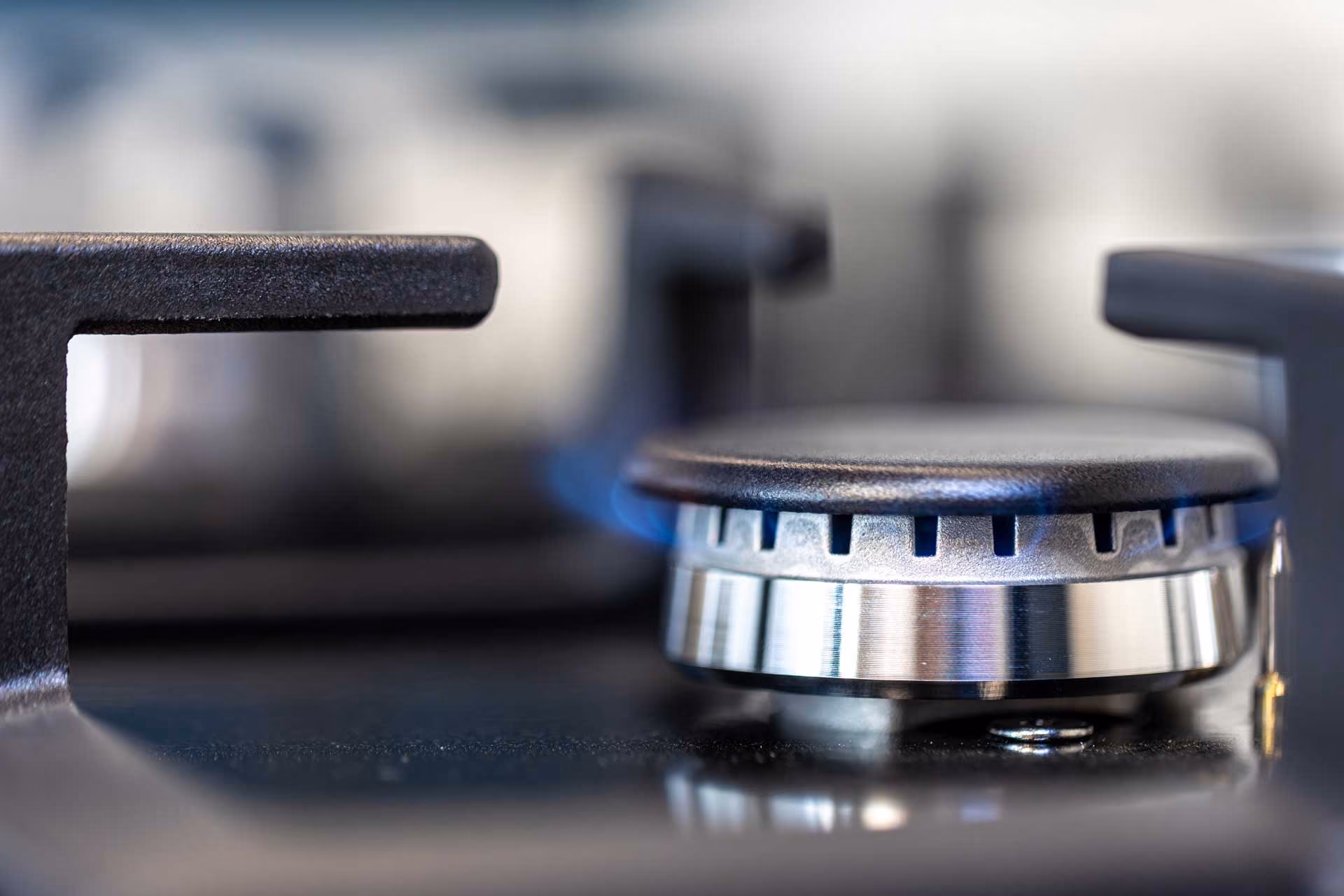 Close-up of a bearing with metal roller cage and industrial machinery in blurred background