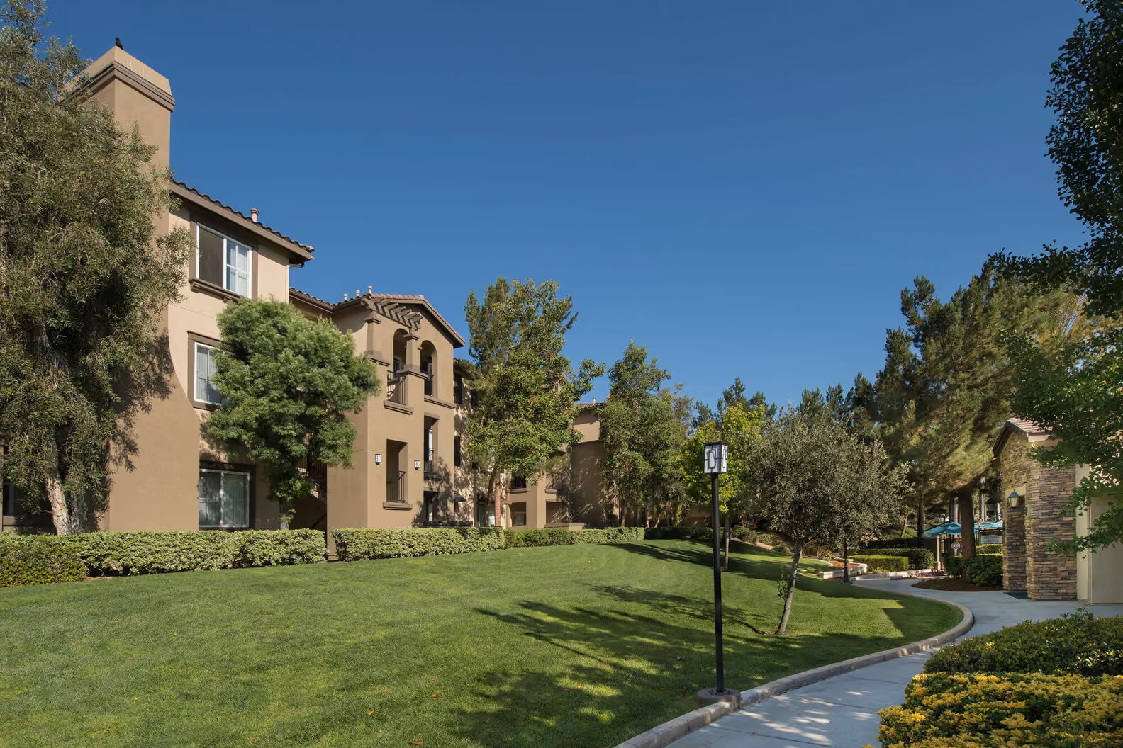 Exterior landscaping with sidewalk through the Esplanade