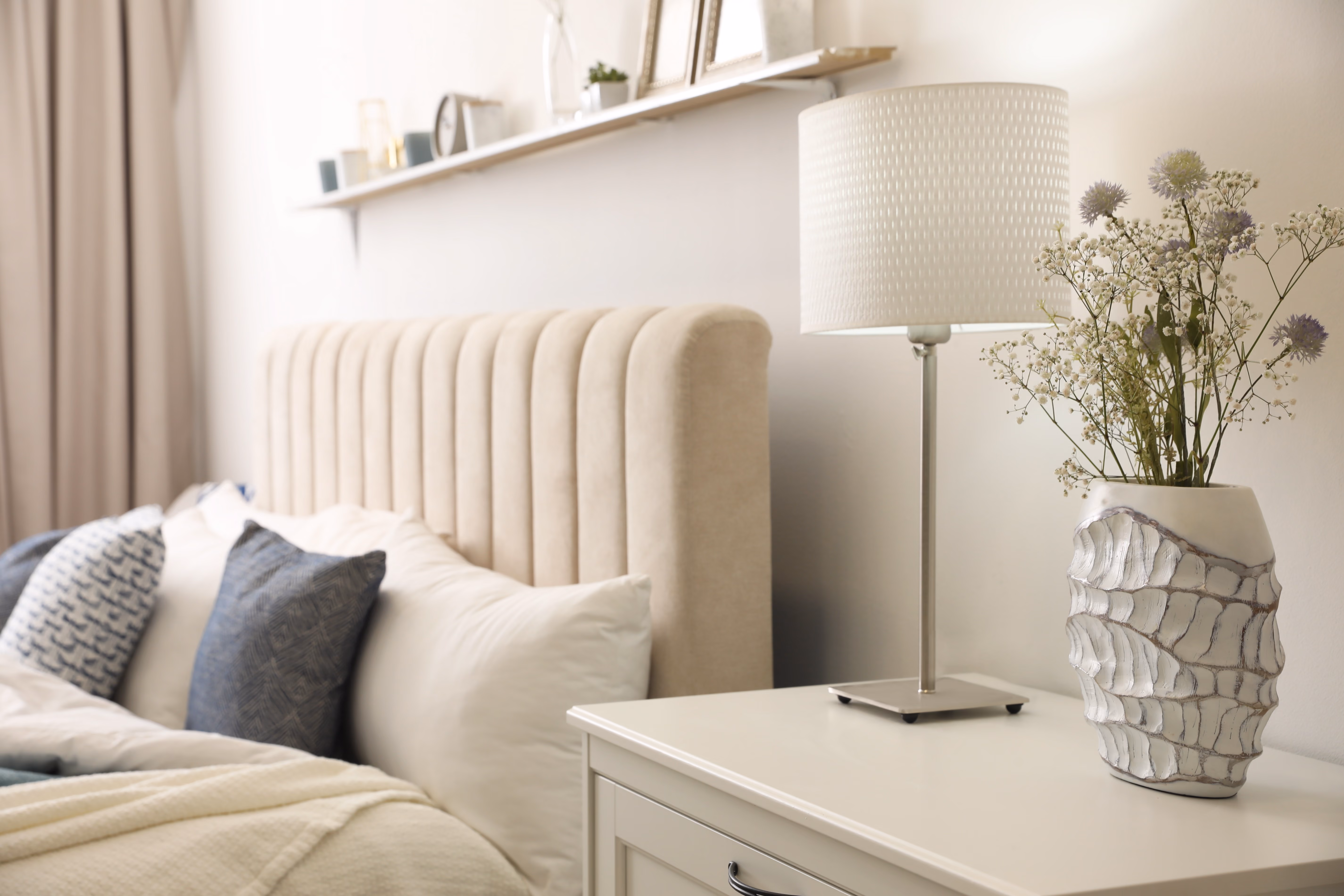 Bed with side table and decor stock image