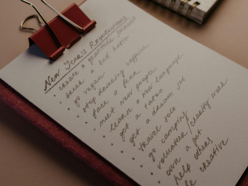 A clipboard with a list of new year's resolutions written out