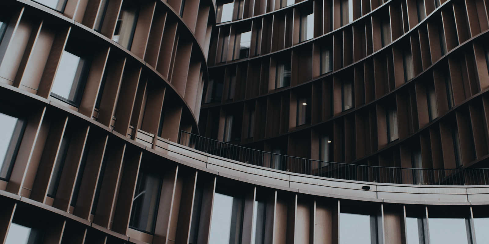 Cylindrical modern high-rise building with curved glass facade